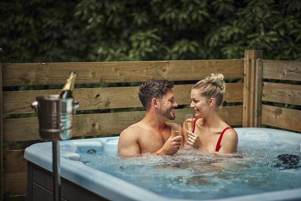 Couple relaxing in a holiday let hot tub